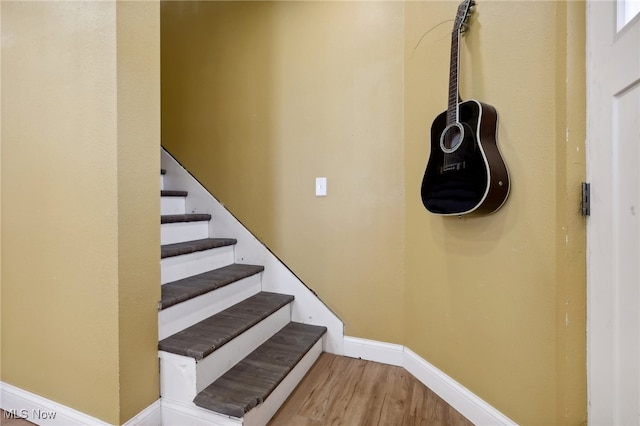 stairs featuring hardwood / wood-style flooring