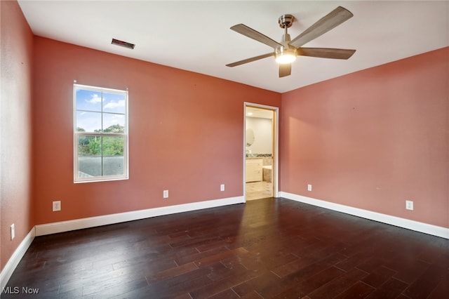 spare room featuring ceiling fan and dark hardwood / wood-style floors