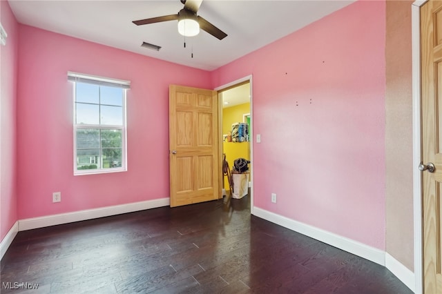 empty room with ceiling fan and dark hardwood / wood-style floors