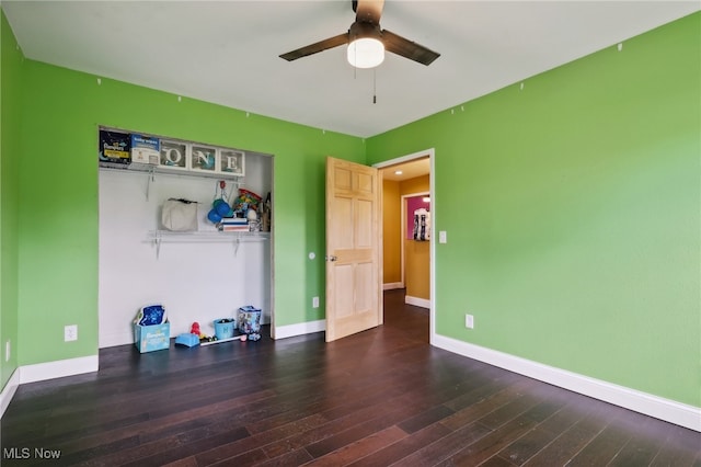 interior space with a closet, ceiling fan, and dark hardwood / wood-style floors