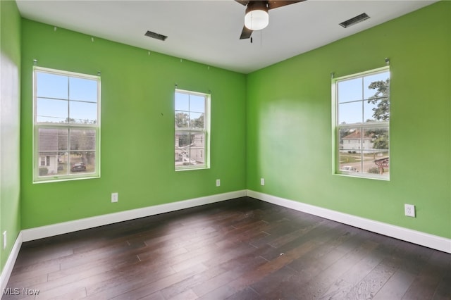 empty room with dark wood-type flooring and ceiling fan