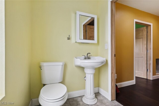 bathroom featuring toilet and hardwood / wood-style floors