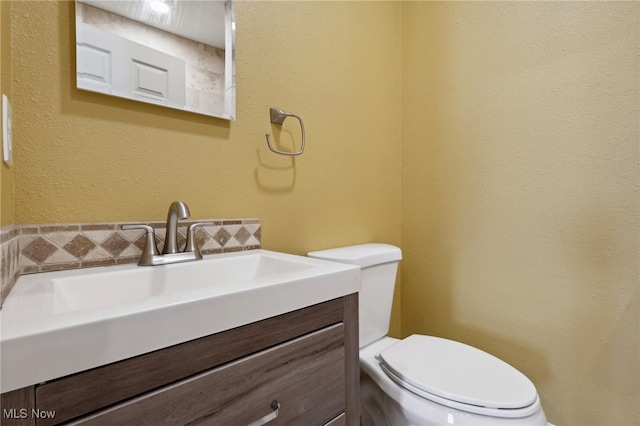 bathroom with toilet and vanity