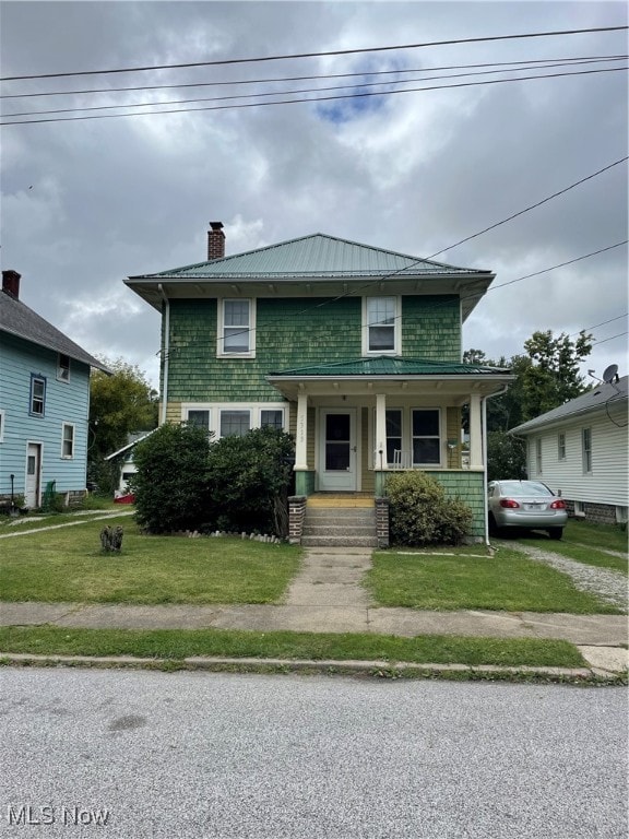 bungalow with a front yard and a porch