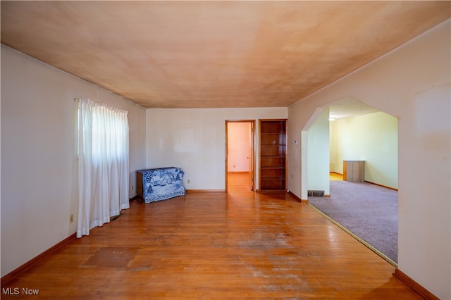 empty room with hardwood / wood-style floors