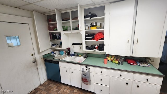 kitchen with dishwasher, white cabinetry, sink, and a drop ceiling