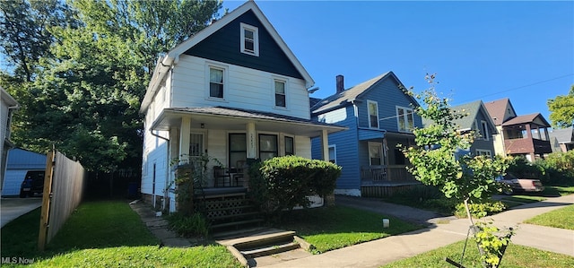 view of front of home featuring a front yard and covered porch