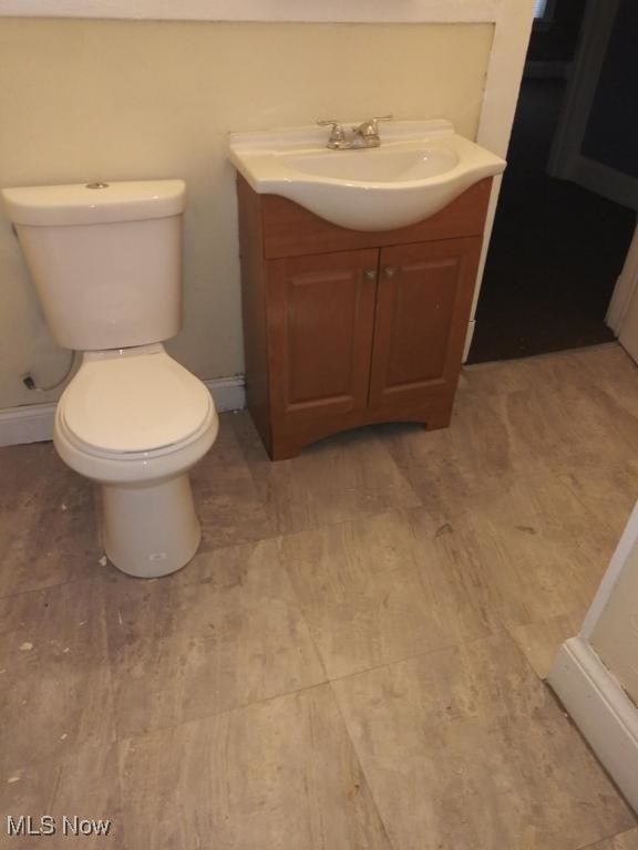 bathroom featuring hardwood / wood-style floors, toilet, and vanity