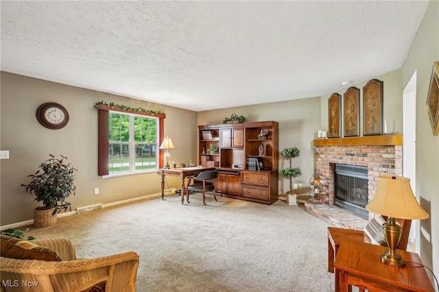 office area with a fireplace, a textured ceiling, and carpet flooring