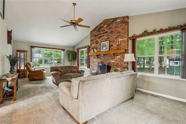 carpeted living room featuring a fireplace, a textured ceiling, vaulted ceiling, and ceiling fan