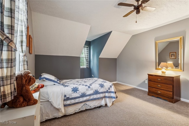 carpeted bedroom with ceiling fan, a textured ceiling, and vaulted ceiling