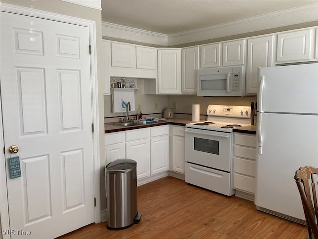 kitchen with ornamental molding, white cabinetry, white appliances, light hardwood / wood-style flooring, and sink