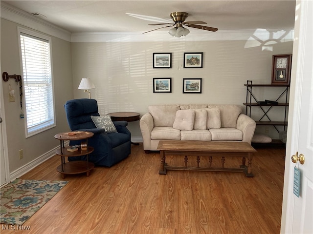 living room featuring ceiling fan, wood-type flooring, and ornamental molding