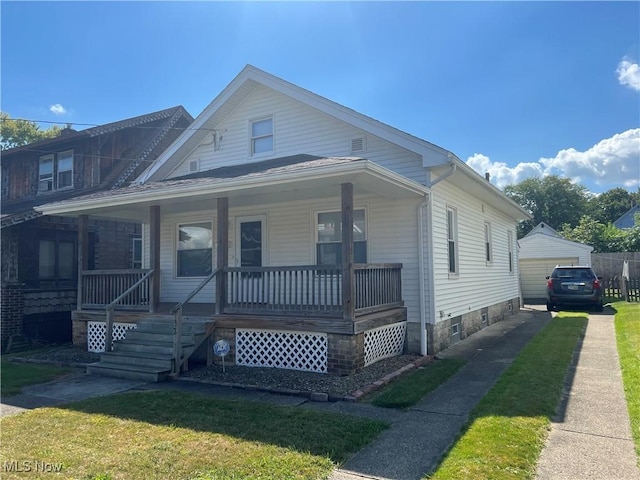 bungalow-style home with a front yard and covered porch