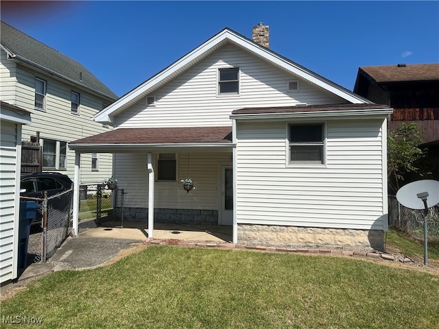 back of property featuring a lawn