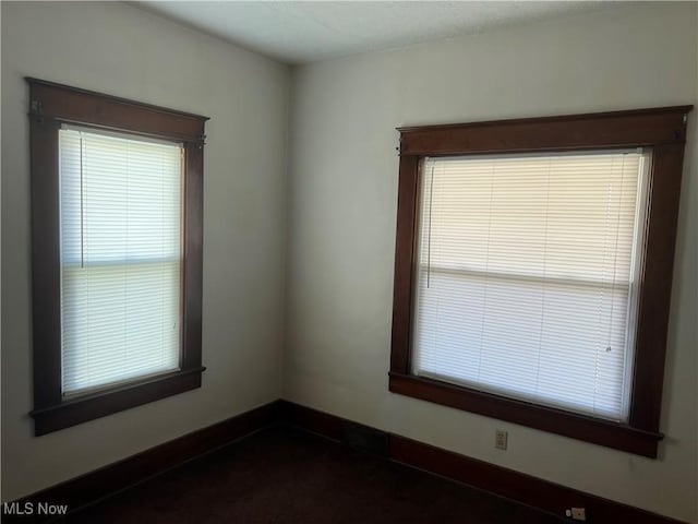 empty room featuring baseboards