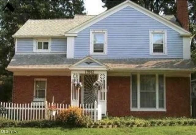 19912 Lanbury Ave, Warrensville Heights, OH 44122 - view of front facade with a porch, fence, and a chimney