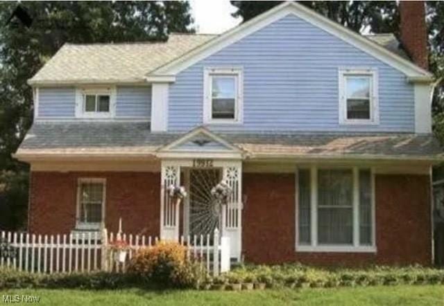 19912 Lanbury Ave, Warrensville Heights, OH 44122 - view of front facade with a porch, fence, and a chimney