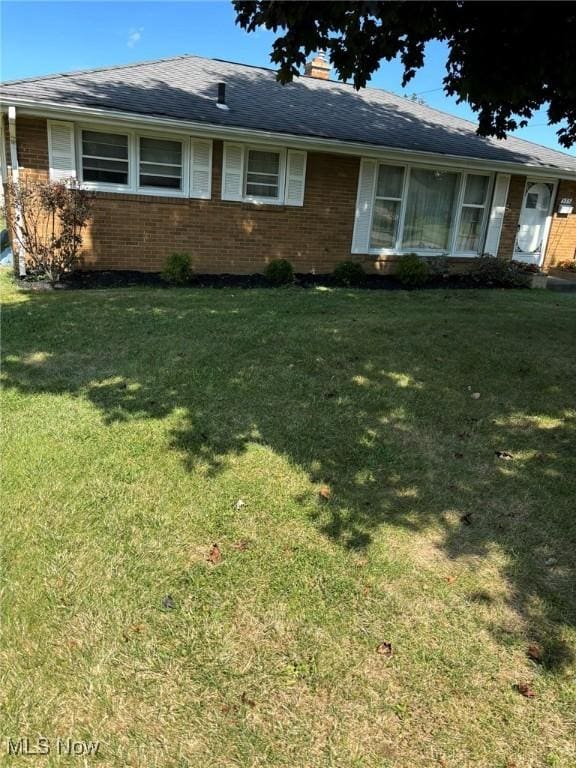 ranch-style home with a front lawn