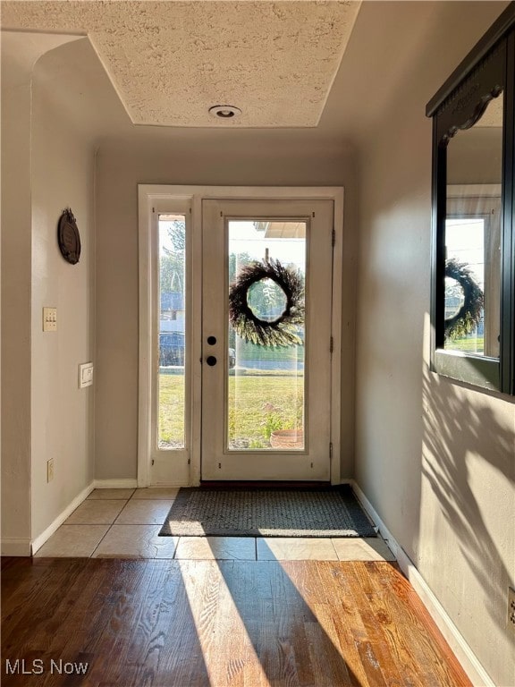 doorway to outside with tile patterned flooring