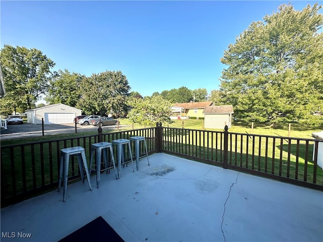 view of patio featuring a storage unit and exterior bar