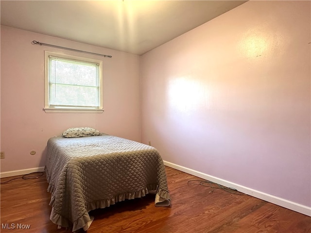 bedroom with wood-type flooring