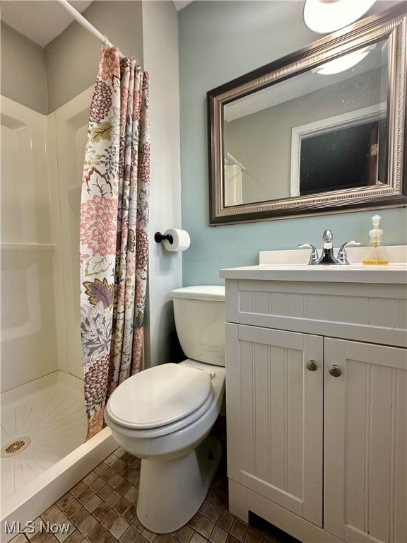 bathroom featuring tile patterned floors, vanity, toilet, and a shower with shower curtain