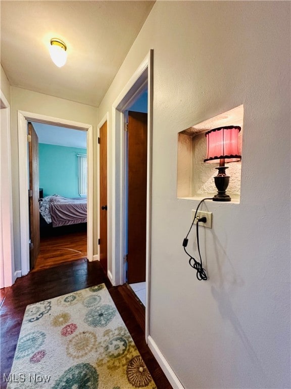 corridor with dark wood-type flooring