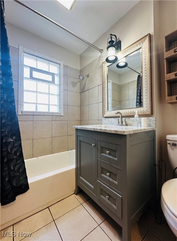 full bathroom featuring tile patterned flooring, vanity, shower / tub combo with curtain, and toilet