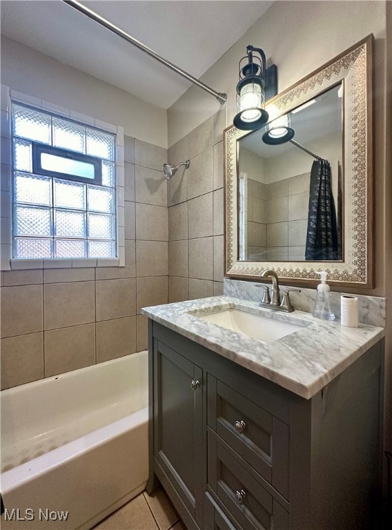 bathroom featuring tile patterned flooring, vanity, and shower / bath combo