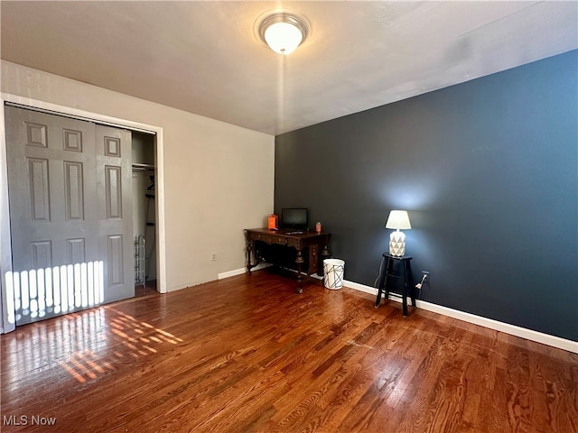 unfurnished bedroom featuring hardwood / wood-style flooring and a closet