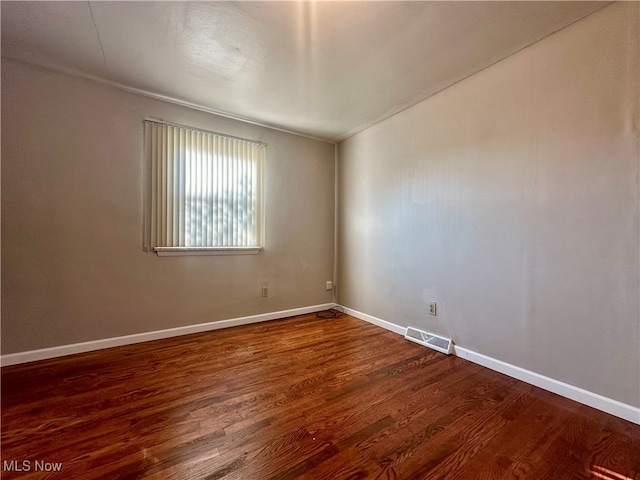 spare room featuring wood-type flooring