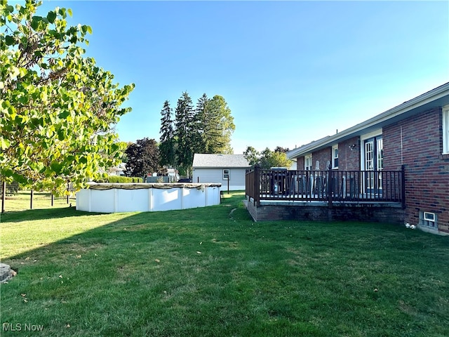 view of yard with a swimming pool side deck