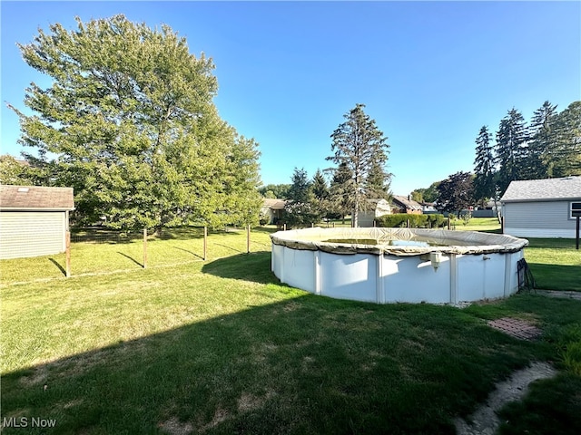 view of yard featuring a covered pool