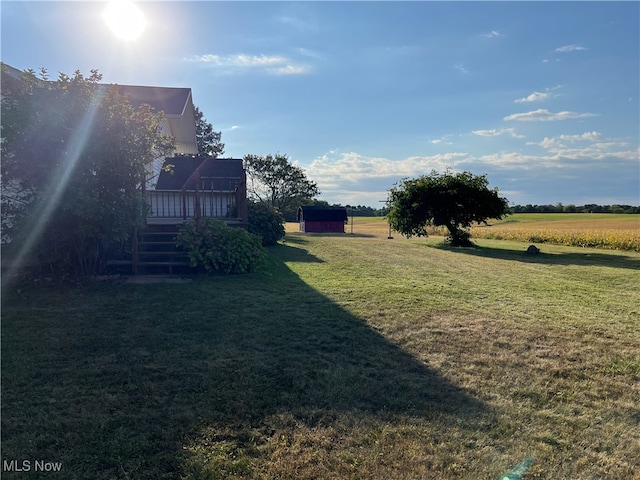 view of yard with a deck and a rural view