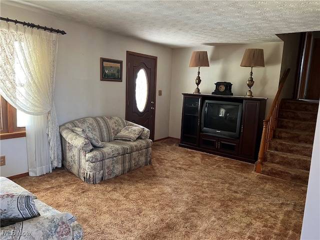 living room featuring a textured ceiling, a wealth of natural light, and carpet floors