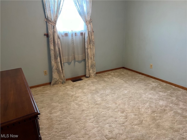 empty room with light colored carpet