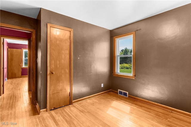 unfurnished bedroom featuring light wood-type flooring