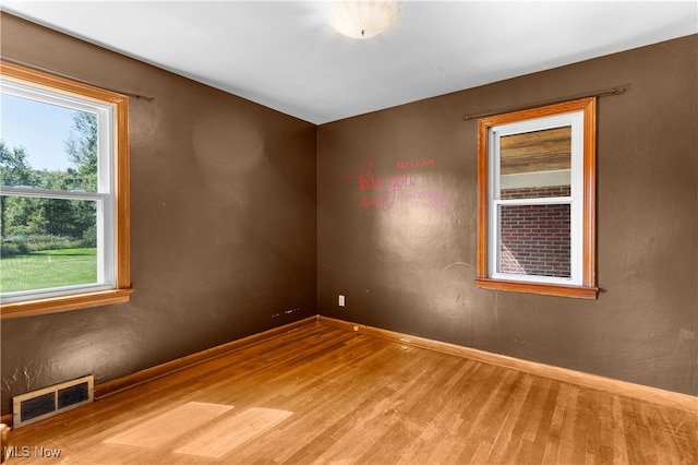 empty room with hardwood / wood-style flooring