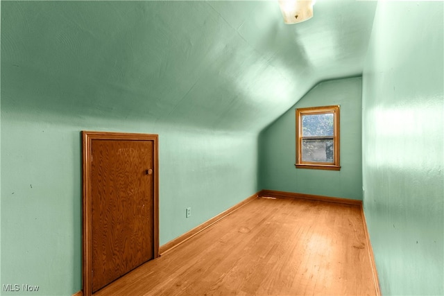 bonus room featuring lofted ceiling and light hardwood / wood-style floors