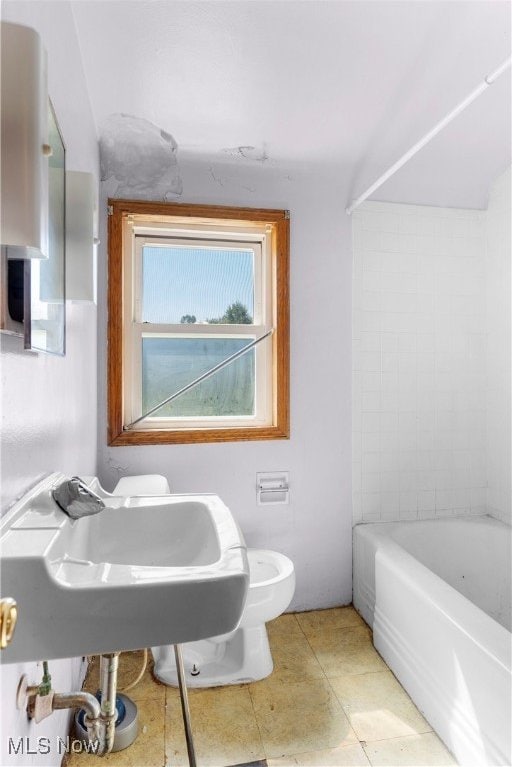 bathroom with bathtub / shower combination, toilet, and tile patterned floors