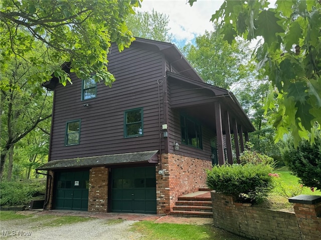 view of side of property featuring cooling unit and a garage