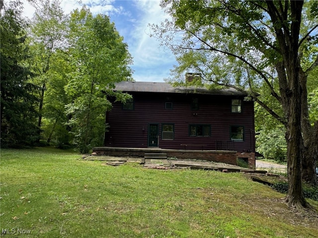 back of house with a yard