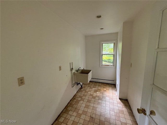 washroom with baseboard heating and sink