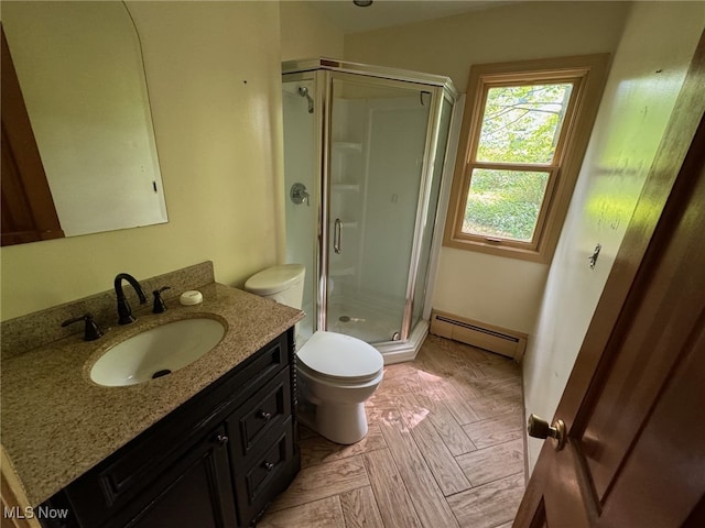 bathroom featuring vanity, toilet, baseboard heating, and walk in shower