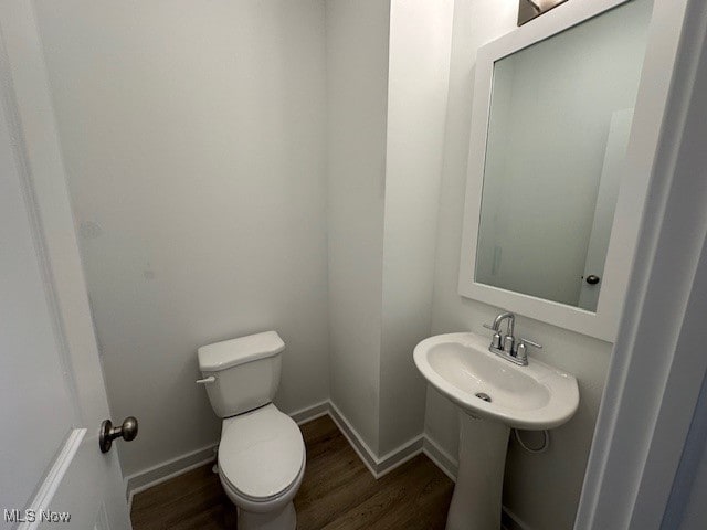 bathroom with wood-type flooring and toilet