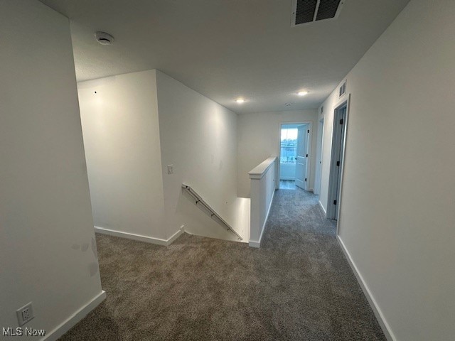 corridor with dark colored carpet