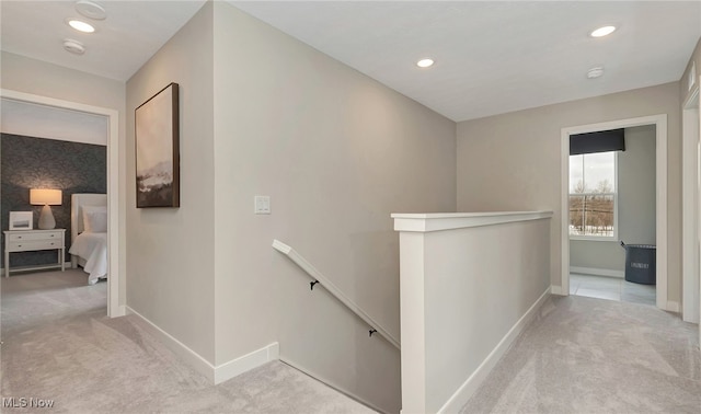 corridor featuring light colored carpet