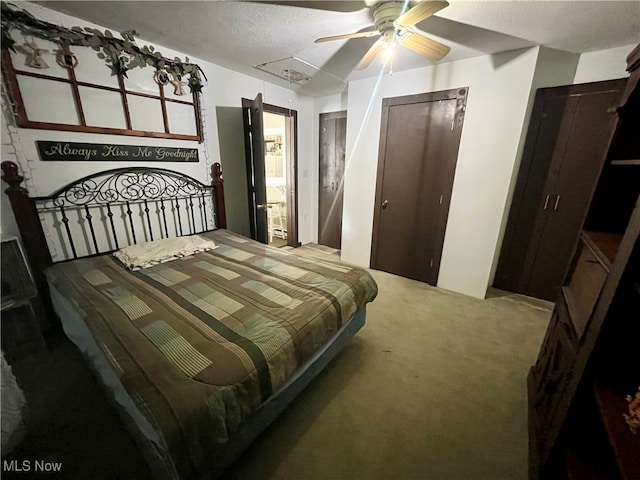 bedroom with a textured ceiling, ceiling fan, and carpet floors