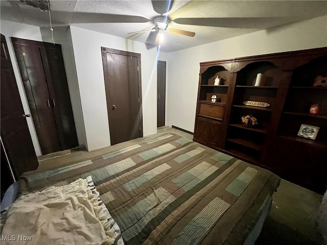 bedroom with a textured ceiling, ceiling fan, and carpet floors